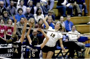 Erin Byrd hitting a volleyball over the net.